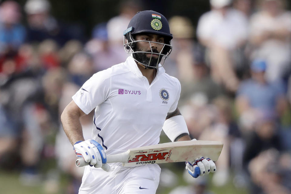 FILE - In this March 1, 2020, file photo, India's Virat Kohli runs a single while batting during play on day two of the second cricket test between New Zealand and India at Hagley Oval in Christchurch, New Zealand. India’s cricket tour to Australia is closer to being formalized with selectors picking squads for a four-test series and the one-day and Twenty20 limited-overs formats. (AP Photo/Mark Baker, File)