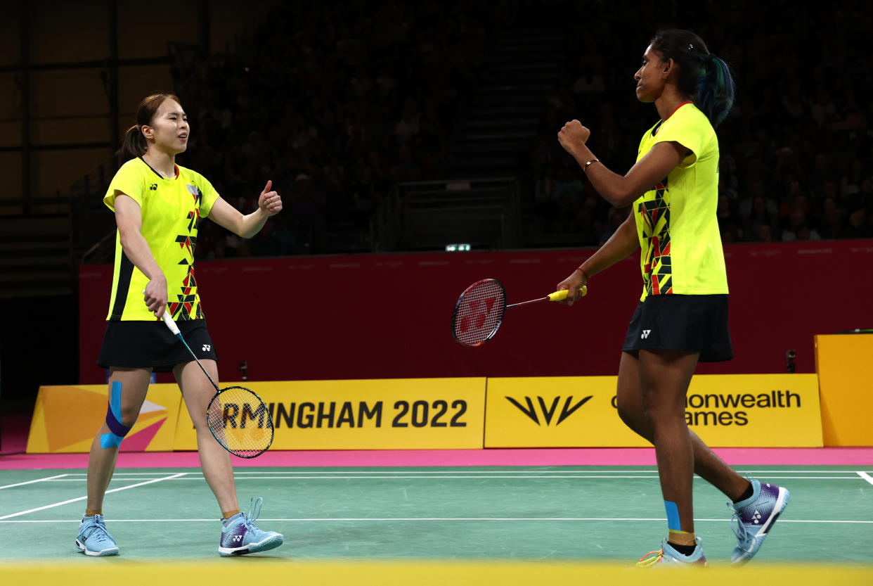 Malaysian shuttlers Pearly Tan and Thinaah Muralitharan celebrate winning a point during the women's doubles final at the 2022 Commonwealth Games in Birmingham.