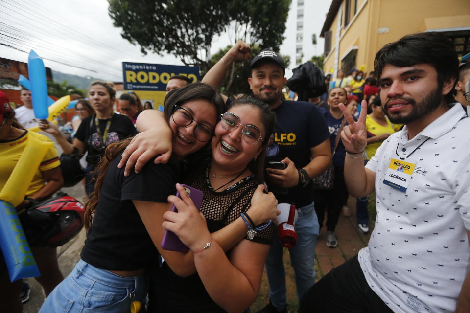 Supporters of Rodolfo Hernandez, presidential candidate with the Anti-corruption Governors League, celebrate as they listen to favorable partial results at his election night headquarters in Bucaramanga, Colombia, Sunday, May 29, 2022. Hernandez will advance to a runoff contest in June after none of the six candidates in Sunday's first round got half the vote. (AP Photo/Mauricio Pinzon)