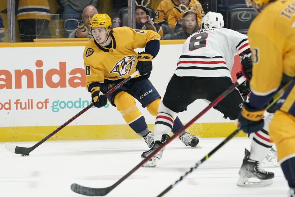 Nashville Predators' Cody Glass, left, moves the puck against Chicago Blackhawks' Dominik Kubalik in the second period of an NHL hockey game Saturday, April 16, 2022, in Nashville, Tenn. (AP Photo/Mark Humphrey)