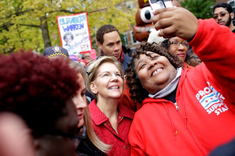 Democratic presidential candidate Senator Elizabeth Warren takes a selfie as she visits a picket line of striking teachers in Chicago