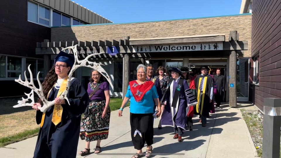 Amber Taylor-Fisher holds the Ceremonial Antler for the Yukon University's convocation procession. This contemporary, cultural ceremonial piece is an ancient symbol, representing the authority of the university as a custodian of the traditions of learning.