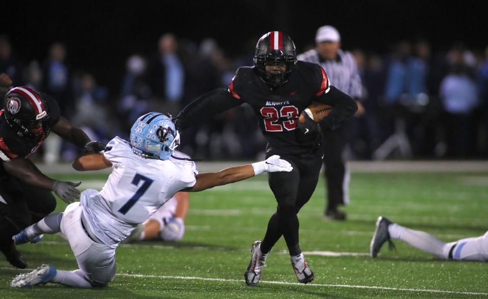 Aliquippa's Tiqwai Hayes (23) stiff arms Central Valley's Jayvin Thompson (7) while sprinting downfield during the second half Friday night at Jimbo Covert Field in Freedom, PA.