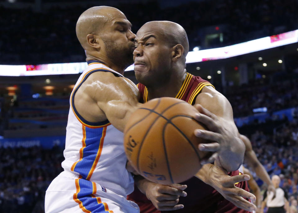 Cleveland Cavaliers guard Jarrett Jack, right, drives past Oklahoma City Thunder guard Derek Fisher during the second quarter of an NBA basketball game in Oklahoma City, Wednesday, Feb. 26, 2014. (AP Photo/Sue Ogrocki)