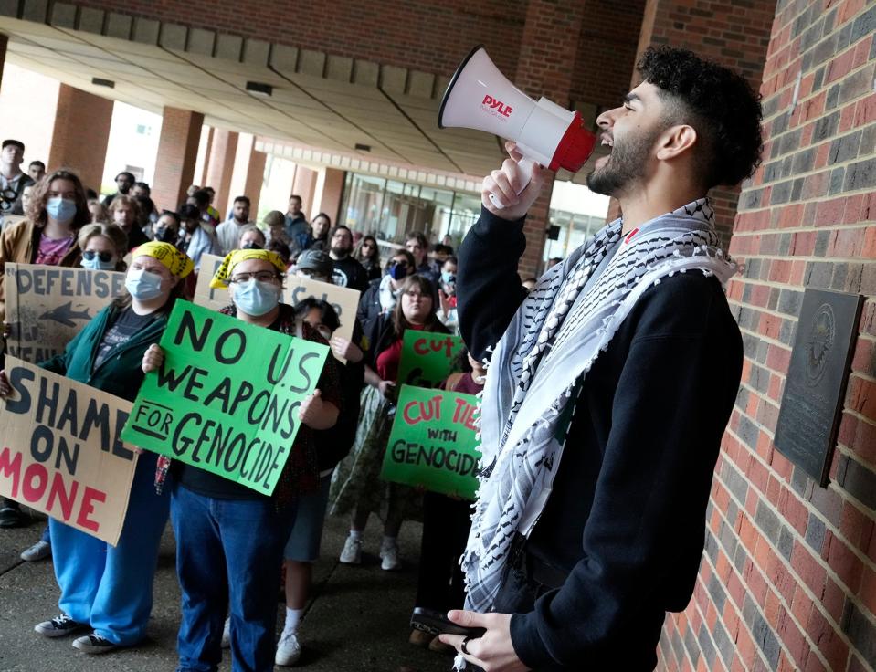 Zaid Dahir, a junior studying healthcare administration, speaks to demonstrators protesting the Israel-Hamas war at a rally on the University of Wisconsin-Milwaukee campus. Dahir is with the Muslim Student Association.
