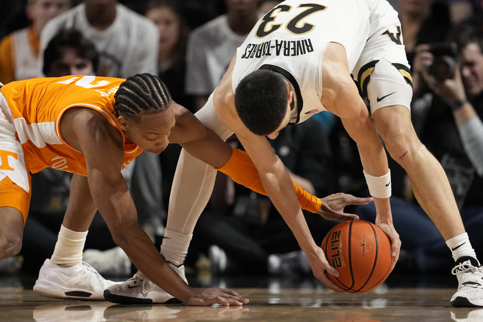 Tennessee guard Jordan Gainey (2) and Vanderbilt guard Jason Rivera-Torres (23) battle for the ball during the first half of an NCAA college basketball game Saturday, Jan. 27, 2024 in Nashville, Tenn. (AP Photo/George Walker IV)