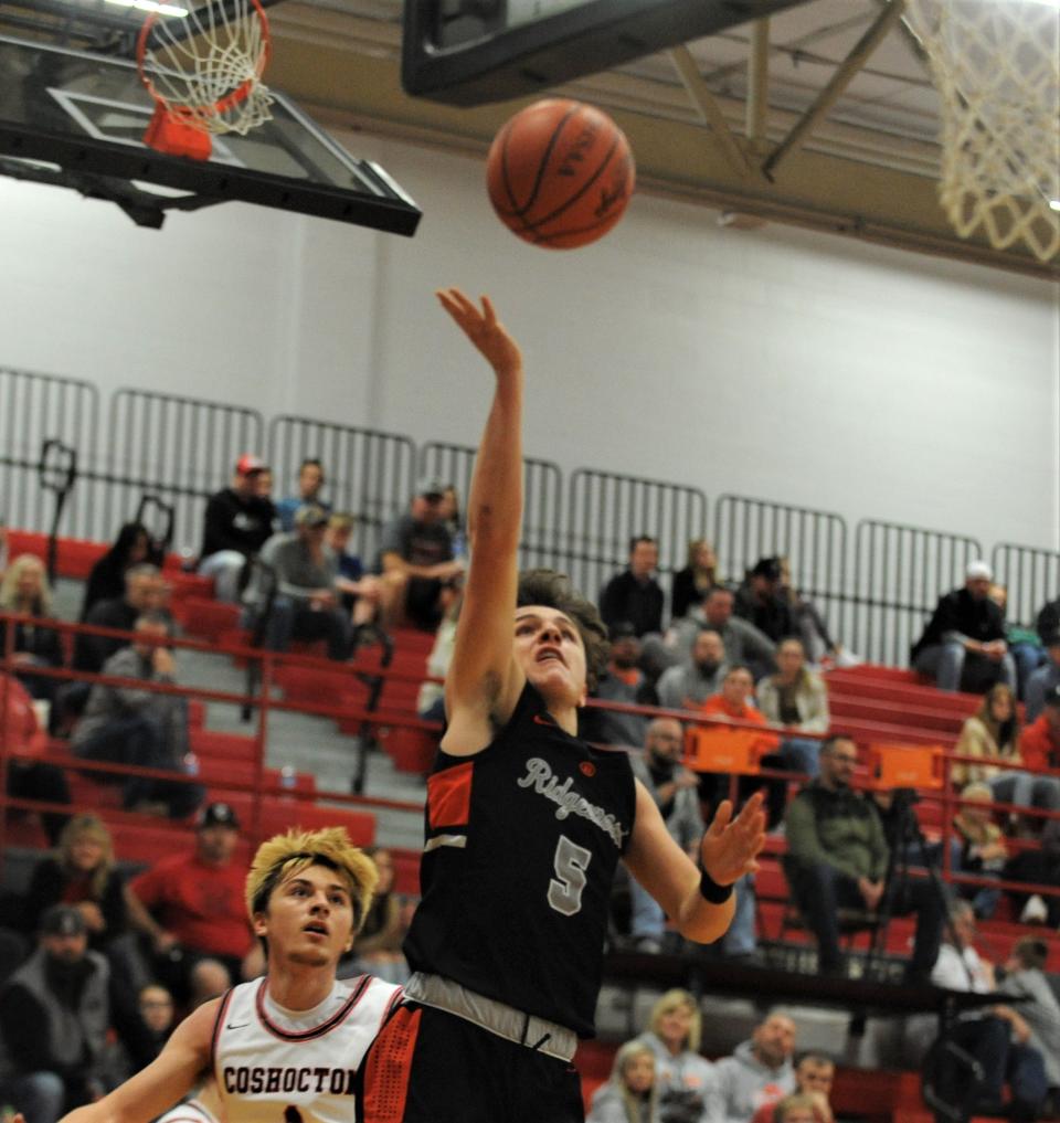 Ridgewood's Zander Stroup lays the ball in during Wednesday's game at Coshocton. The Generals won 68-62.