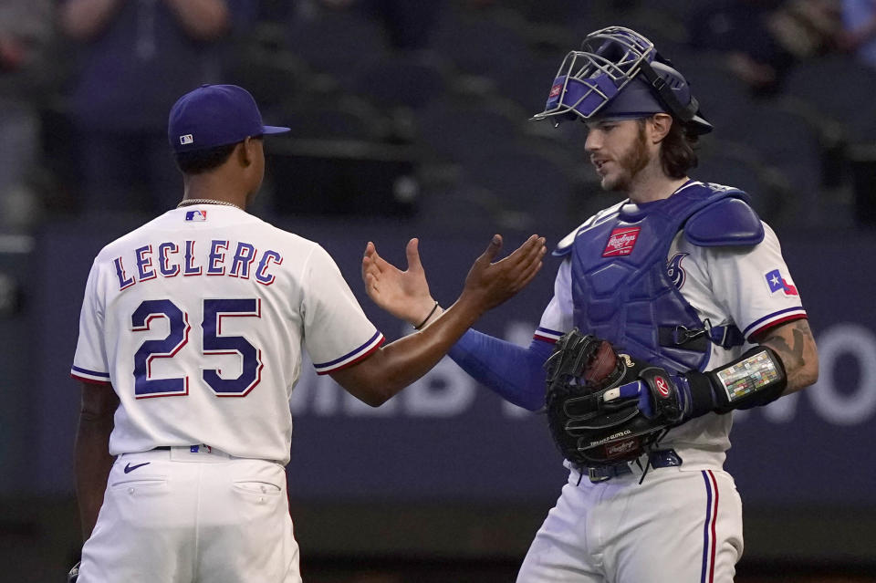 Texas Rangers closer Jose Leclerc (25) is congratulated by catcher Jonah Heim after logging the final strike out of a baseball game against the Baltimore Orioles in Arlington, Texas, Wednesday, April 5, 2023. (AP Photo/LM Otero)
