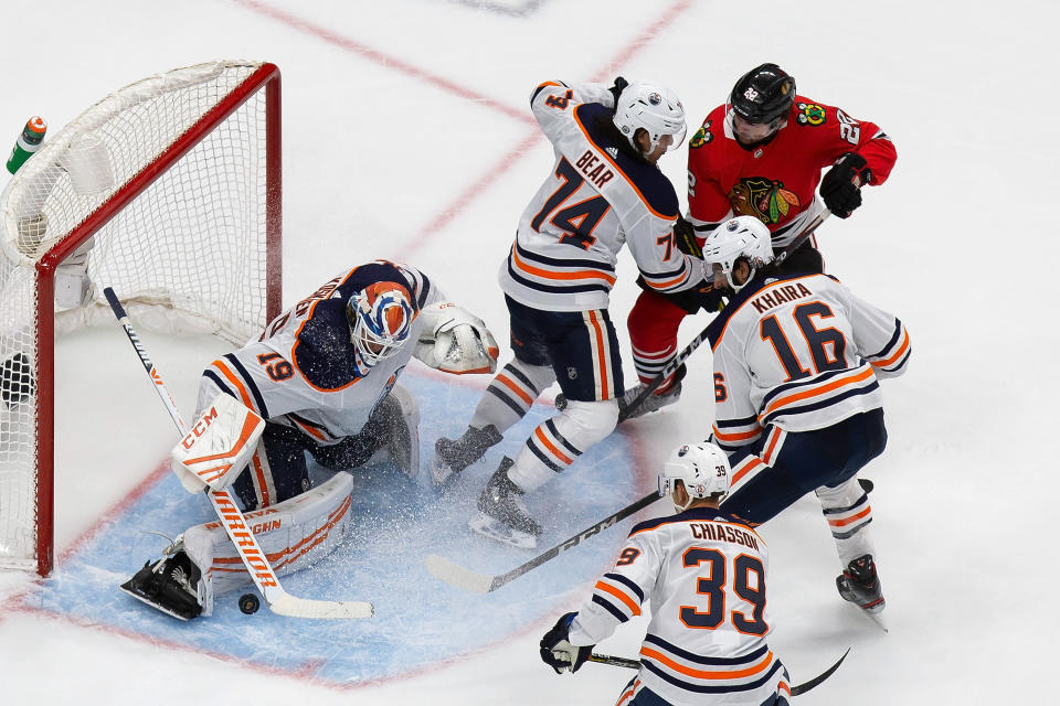 Edmonton Oilers goaltender Mikko Koskinen (19) makes a save against Chicago Blackhawks' Ryan Carpenter (22) during the third period of an NHL hockey playoff game Wednesday, Aug. 5, 2020, in Edmonton, Alberta. (Codie McLachlan/The Canadian Press via AP)