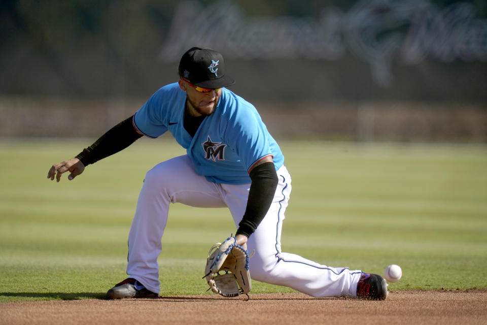 Miami Marlins infielder Isan Diaz handles a grounder during spring training baseball practice Friday, Feb. 26, 2021, in Jupiter, Fla. (AP Photo/Jeff Roberson)