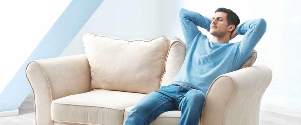 Happy young man relaxing at home