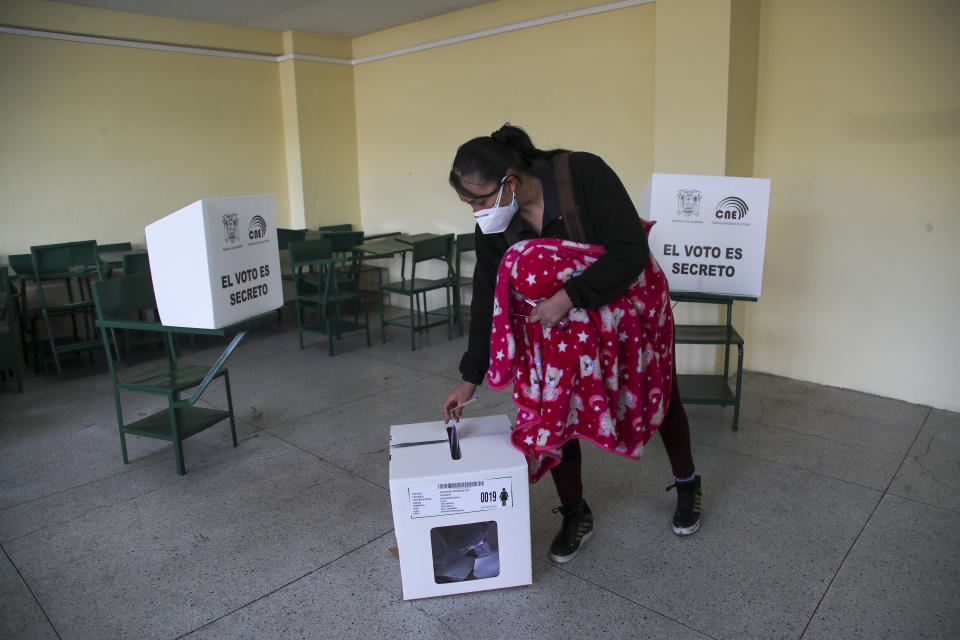 A woman votes during a runoff presidential election in Quito, Ecuador, Sunday, April 11, 2021. (AP Photo/Dolores Ochoa)