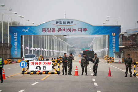 South Korean soldiers stand guard at a checkpoint on the Grand Unification Bridge that leads to the Peace House, the venue for the Inter-Korean summit, near the demilitarized zone separating the two Koreas, in Paju, South Korea, April 26, 2018. REUTERS/Kim Hong-Ji