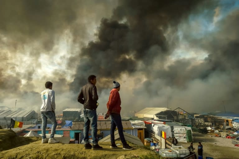 Firefighters, volunteers and migrants joined forces against the fires that ravaged many of the ramshackle dwellings at the lawless Jungle