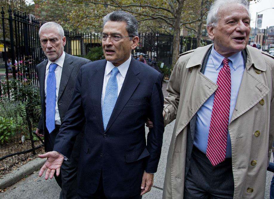Former Goldman Sachs and Procter & Gamble Co. board member Rajat Gupta, center, arrives outside court in New York Wednesday, Oct. 24, 2012. Gupta is to be sentenced after being found guilty insider trading by passing secrets between March 2007 and January 2009 to a billionaire hedge fund founder who used the information to make millions of dollars. At right is Gupta's attorney Gary Naftalis. (AP Photo/Craig Ruttle)