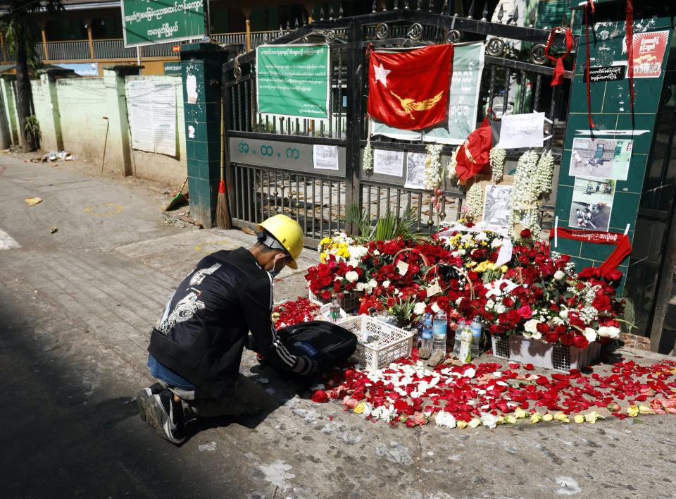 <p>A man lays flowers at a memorial for Nyi Nyi Aung Htet Naing, a 23-year-old protester who was killed during a crackdown on anti-coup protesters in Yangon, Myanmar </p> (EPA)