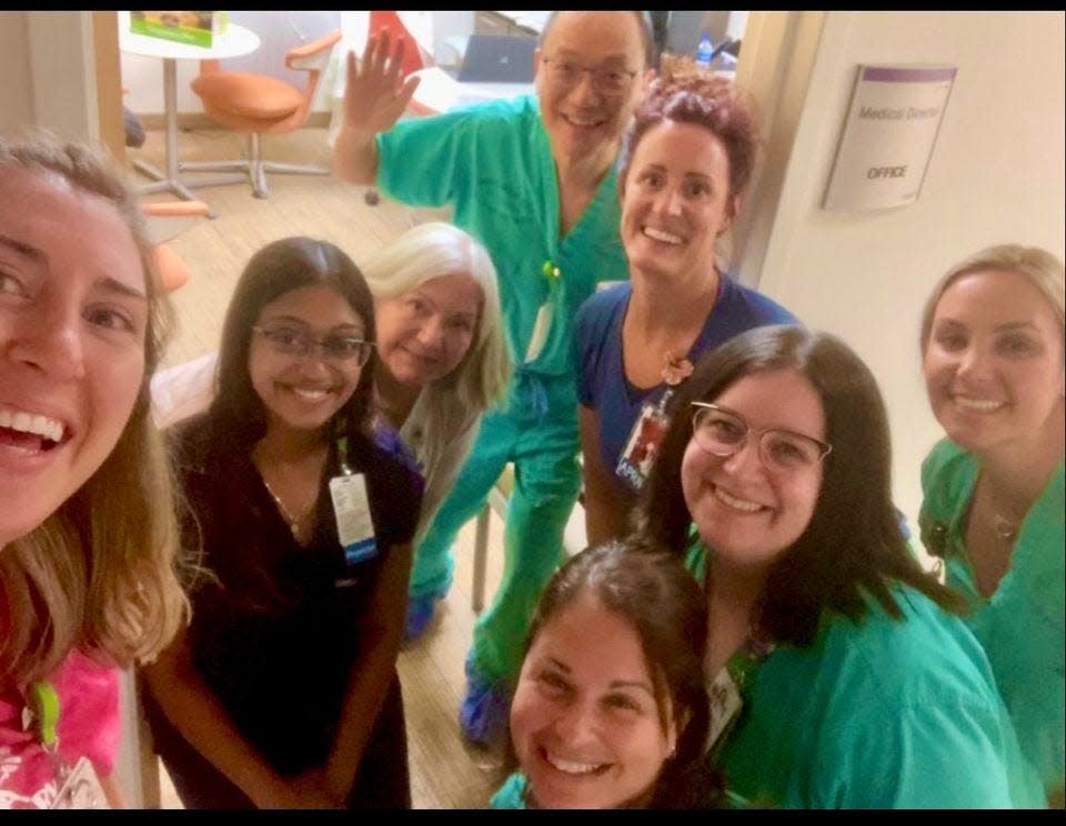 This is a group photo taken on Tuesday, Sept 27, 2022, one day before the arrival of Hurricane Ian. These are several members of the  Golisano Children's Hospital NICU staff Team A, including the head of the department, Dr. William Lui (waving).