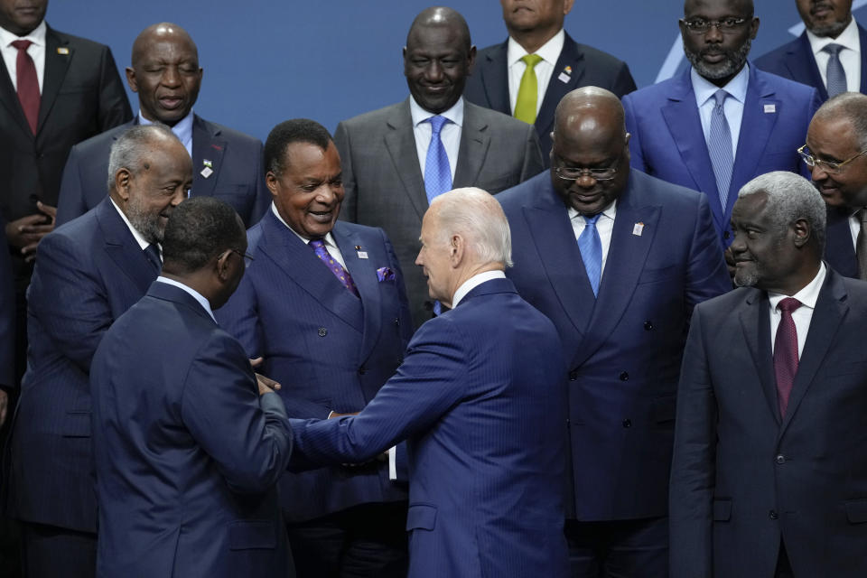 President Joe Biden speaks with African leaders as they gather to pose for a family photo during the U.S.-Africa Leaders Summit in Washington, Thursday, Dec. 15, 2022. Front row from left, Senegal's President Macky Sall, Biden and African Union Commission (AUC) chair Moussa Faki Mahamat. Second row from left, Djibouti's President Ismail Omar Guelleh, Republic of Congo's President Denis Sassou Nguesso, and President of the Democratic Republic of the Congo Félix Tshisekedi. (AP Photo/Susan Walsh)