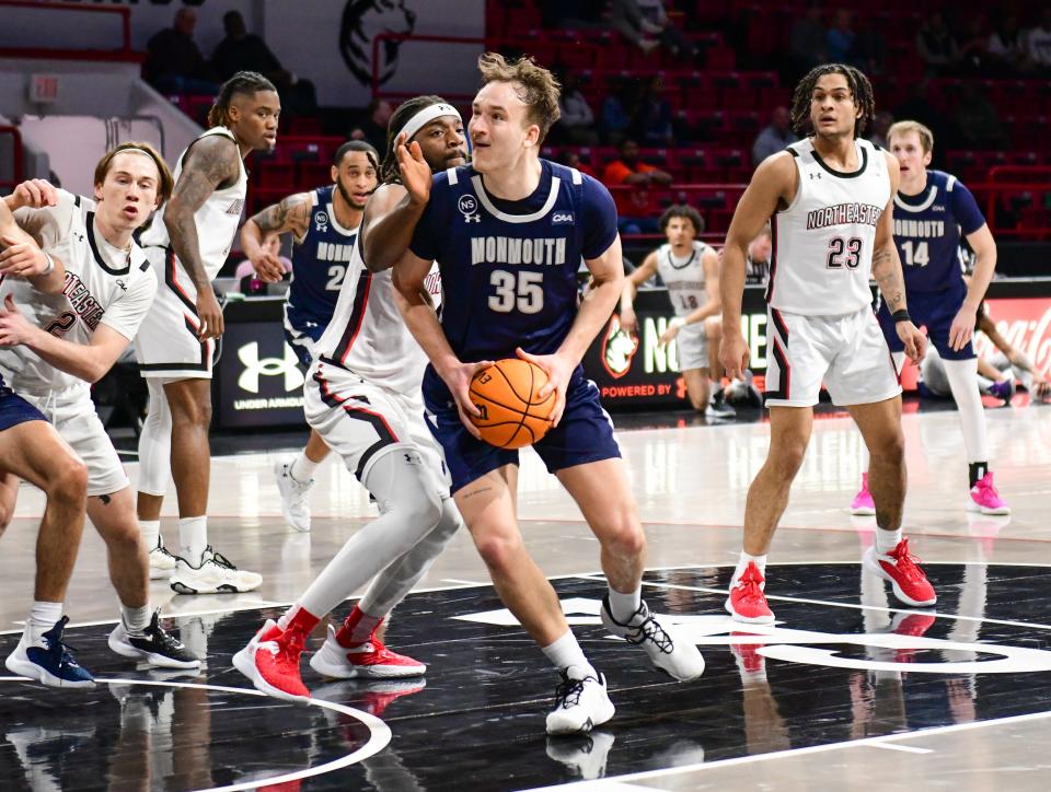 Monmouth's Klemen Vuga spins to the basket against Northeastern at Matthews Arena in Boston, Massachusetts on Feb. 16, 2023.