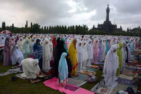 Muslims attend prayers for Eid Al-Fitri near Bajra Sandhi Monument in Denpasar, Bali, Indonesia June 25, 2017 in this photo taken by Antara Foto. Antara Foto/Wira Suryantala/ via REUTERS