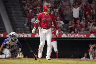 Los Angeles Angels' Shohei Ohtani, right, heads to first as he hits a two-run home run as Colorado Rockies catcher Elias Diaz watches during the sixth inning of a baseball game against the Colorado Rockies Tuesday, July 27, 2021, in Anaheim, Calif. (AP Photo/Mark J. Terrill)