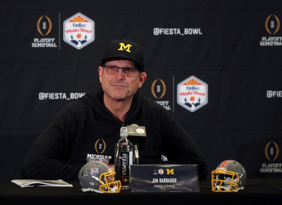 Michigan coach Jim Harbaugh talks with reporters before the Fiesta Bowl against TCU on Thursday, Dec. 29, 2022, in Scottsdale, Arizona.