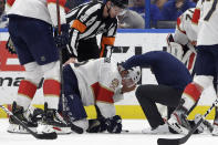 Blood pours out of Florida Panthers defenseman Anton Stralman's helmet after he was hit on the head by a slap shot during the third period of the team's NHL hockey game against the Tampa Bay Lightning on Monday, Dec. 23, 2019, in Tampa, Fla. (AP Photo/Chris O'Meara)