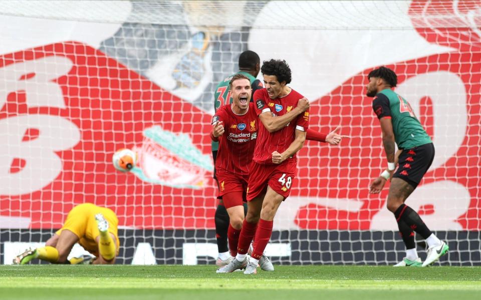 Liverpool's Curtis Jones (right) celebrates scoring his side's second goal of the game with Jordan Henderson - PA