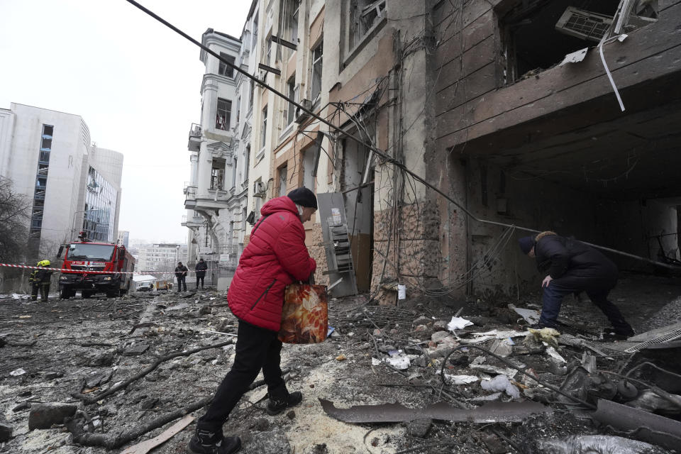 Owners of apartments enter a residential building which was hit by a Russian rocket at the city center of Kharkiv, Ukraine, Sunday, Feb. 5, 2023. (AP Photo/Andrii Marienko)