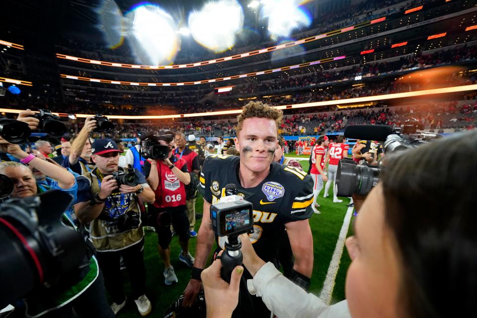 Missouri quarterback Brady Cook is interviewed after the team's win over Ohio State in the Cotton Bowl NCAA college football game Friday, Dec. 29, 2023, in Arlington, Texas. (AP Photo/Julio Cortez)