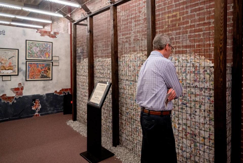 Visitors browse the new exhibit at the American Philatelic Society, “A Philatelic Memorial of the Holocaust,” on Wednesday. The exhibit includes 11 million stamps to represent the lives lost during the Holocaust.