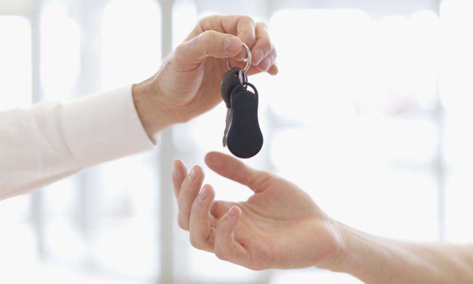 Car salesman handing keys to customer