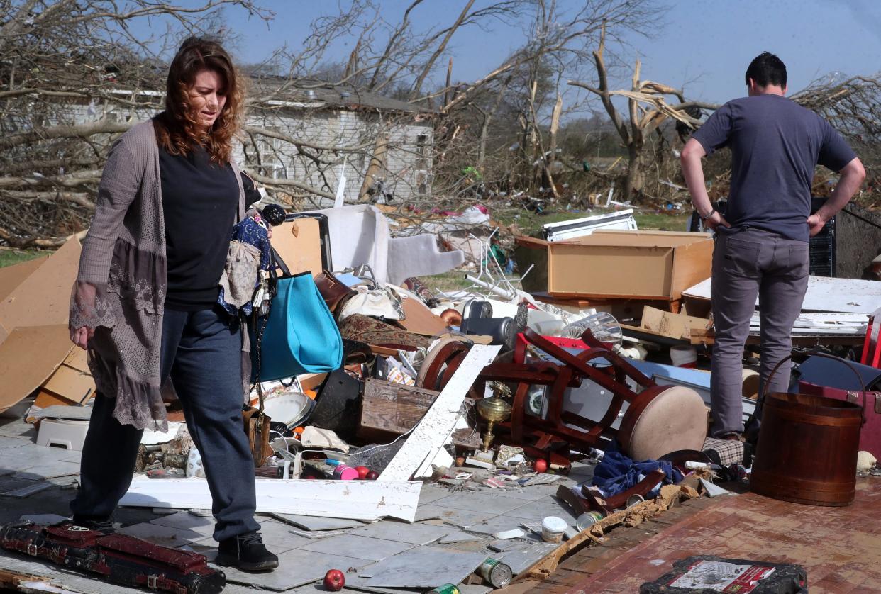 Peggy Flitcraft and her son Brendon Cox try to salvage items from Flitcraft's home and try to find her pet cat from her home that was destroyed from an early-morning tornado along Readyville street as clean-up begins on Saturday, April 1, 2023, in Rutherford County's part of the Readyville community. Flitcraft's cat Salem was later found alive and well in the rubble.