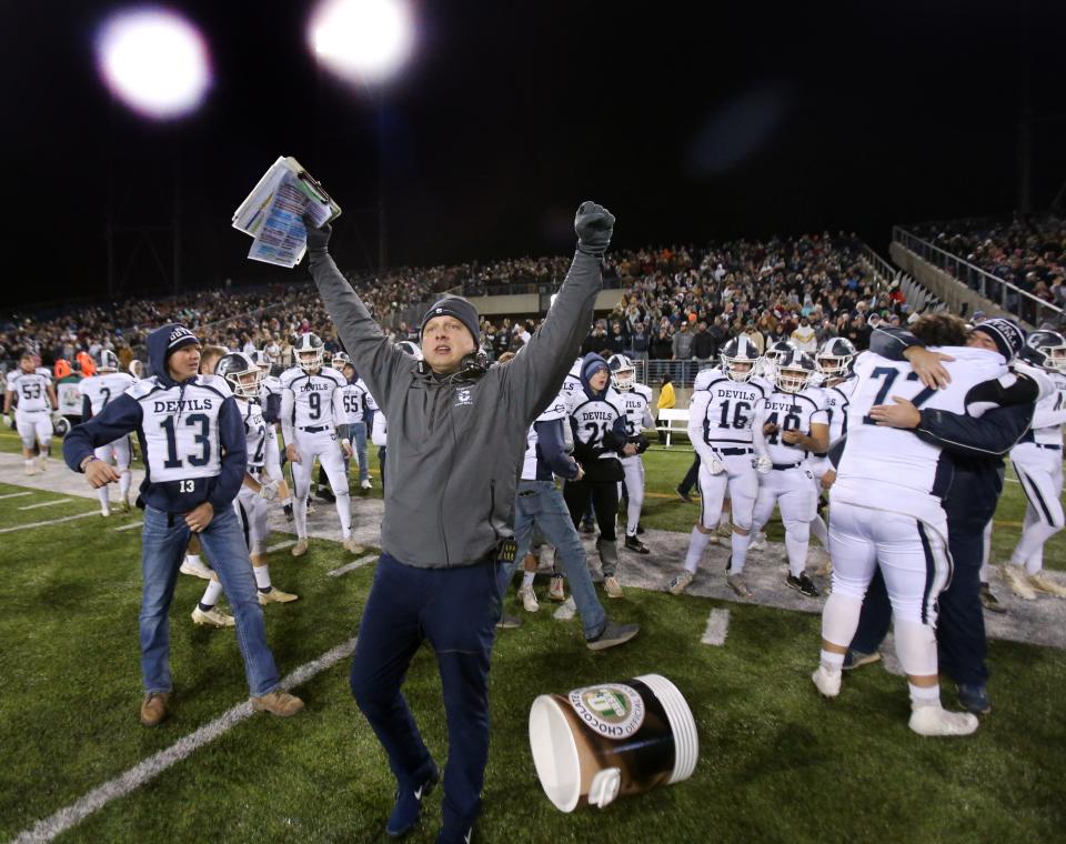 Carey celebrates its victory over Coldwater after their DVI state championship game at Tom Benson Hall of Fame Stadium on Saturday, Dec. 4, 2021. 