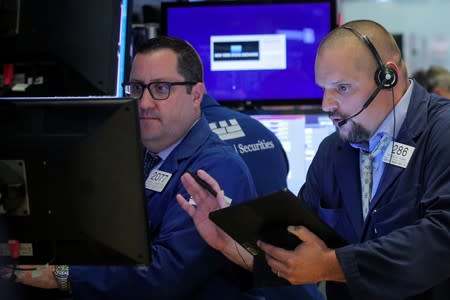 Traders work on the floor at the NYSE in New York