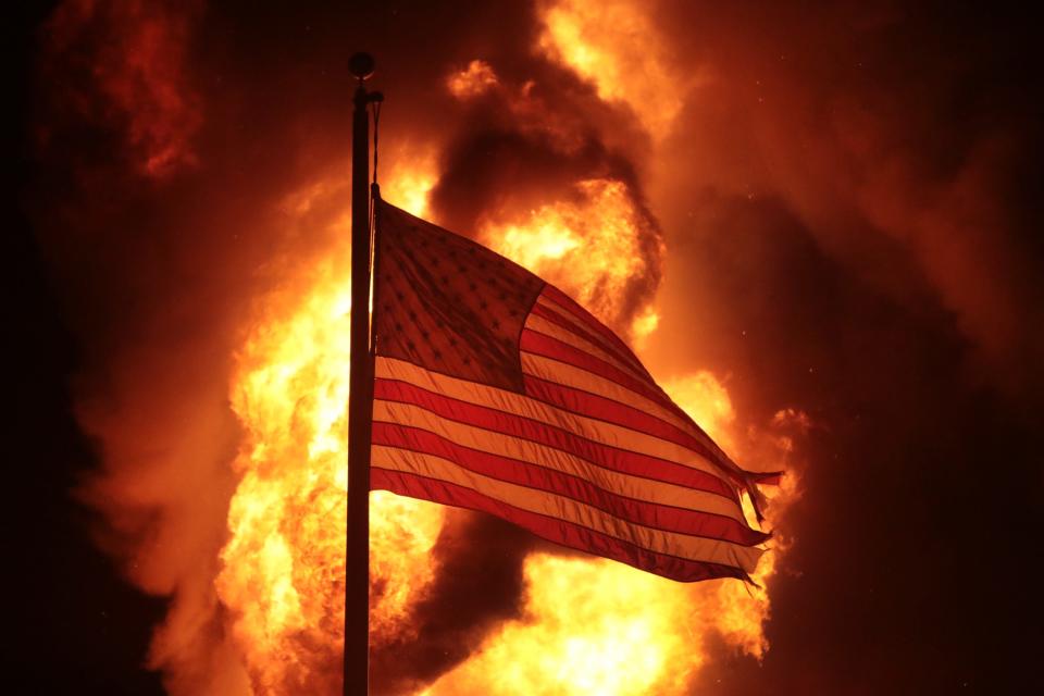 A flag in front of a corrections building that was set ablaze in protests on Aug. 24, 2020, in Kenosha, Wisconsin.