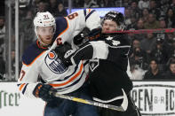 Edmonton Oilers center Connor McDavid, left, and Los Angeles Kings defenseman Mikey Anderson battle during the first period in Game 6 of an NHL hockey Stanley Cup first-round playoff series Thursday, May 12, 2022, in Los Angeles. (AP Photo/Mark J. Terrill)