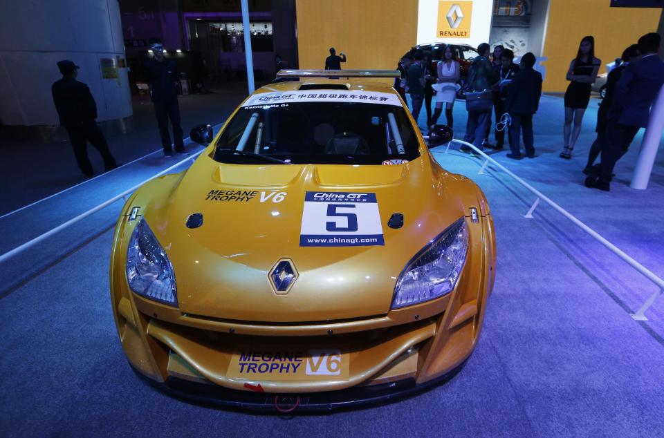 In this Nov. 21, 2013 photo, a Renault Megane Tropy race car is displayed at the company's booth during the Guangzhou 2013 Auto Show in China's southern city of Guangzhou. French automakers Renault and Peugeot are looking belatedly to China to revive their flagging fortunes but picked a tough time to try to expand. Europe’s auto sales slumped in 2013 to their lowest level since 1995, forcing French brands to join U.S. and European rivals in looking to China to drive revenues. (AP Photo/Kin Cheung)