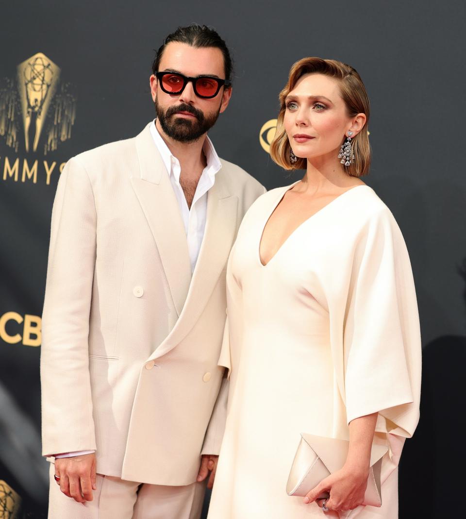 Robbie Arnett and Elizabeth Olsen attend the 2021 Emmys.