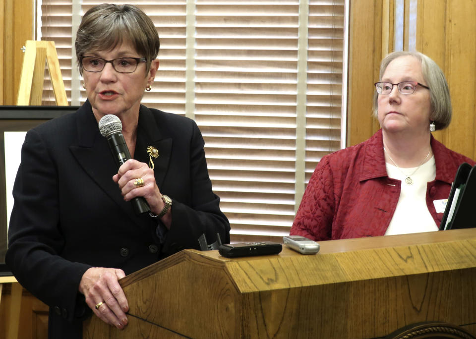 Kansas Gov. Laura Kelly, left, speaks to reporters about food assistance for the needy as Secretary for Children and Families Laura Howard listens during a news conference, Thursday, July 11, 2019, at the Statehouse in Topeka, Kansas. Kelly on Thursday dropped a policy that allowed several thousand Kansas adults to keep receiving food assistance after failing to meet a work requirement, reversing course days after the state’s Republican attorney general threatened to file a lawsuit. (AP Photo/John Hanna)