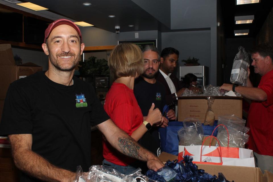 Anthony Setaro, a Red Bank Classic committee member, prepares swag bags for the 5K charity run on Saturday, June 18.