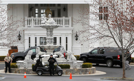 Security personnel stand watch as U.S. President Donald Trump's motorcade arrives at the Trump National Golf Club in Potomac Falls, Virginia, U.S., March 26, 2017. REUTERS/Joshua Roberts