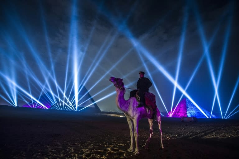 An Egyptian policeman riding a camel stands guard during celebrations in front of the pyramids on January 1, 2016