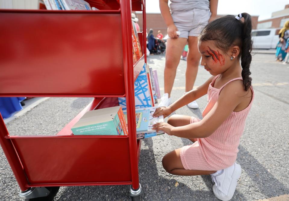 Gabriela Simijaca picks out a book during Refugee Back to School Night at Granite Park Junior High in South Salt Lake on Monday, Aug. 7, 2023. | Kristin Murphy, Deseret News