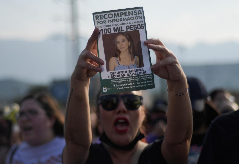 A woman holds up a reward poster during a protest after the death of Debanhi Escobar, an 18-year-old law student who vanished on April 9 amid a spate of disappearances of women in Nuevo Leon's state, in Monterrey Mexico April 22, 2022. / Credit: STRINGER / REUTERS