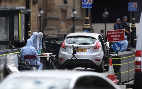 Police forensics officers surround the car where it crashed on Tuesday morning - Credit: Victoria Jones /PA