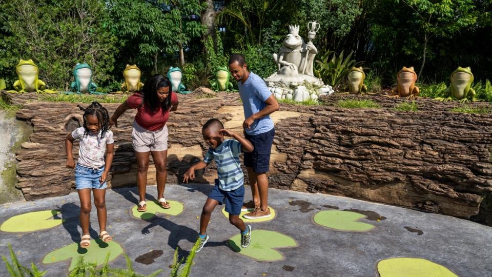 Kids jumping around on King Harold's Swamp Symphony at DreamWorks Land