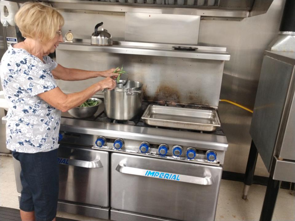 Darlene Leonard cooks a pot of beans freshly picked from Our Lady of Good Counsel Church’s garden in Endicott. Vegetables grown at the garden are used in the church’s soup kitchen. Leonard volunteers for both ministries.