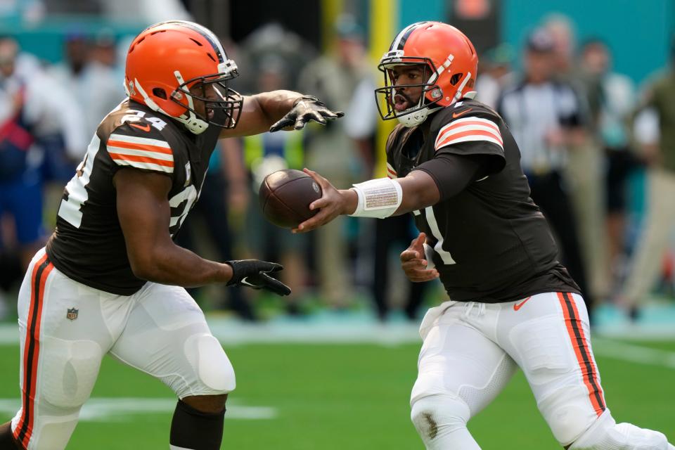 Cleveland Browns quarterback Jacoby Brissett (7) hands the back to running back Nick Chubb (24) during the first half of an NFL football game against the Miami Dolphins, Sunday, Nov. 13, 2022, in Miami Gardens, Fla. (AP Photo/Lynne Sladky)