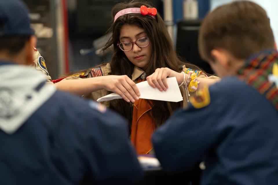 Mar 20, 2024; Prospect Park, NJ, USA; Isabella Rivera makes a paper airplane during a meeting of Prospect Park Cub Scout Pack 2 at Prospect Park Elementary School.